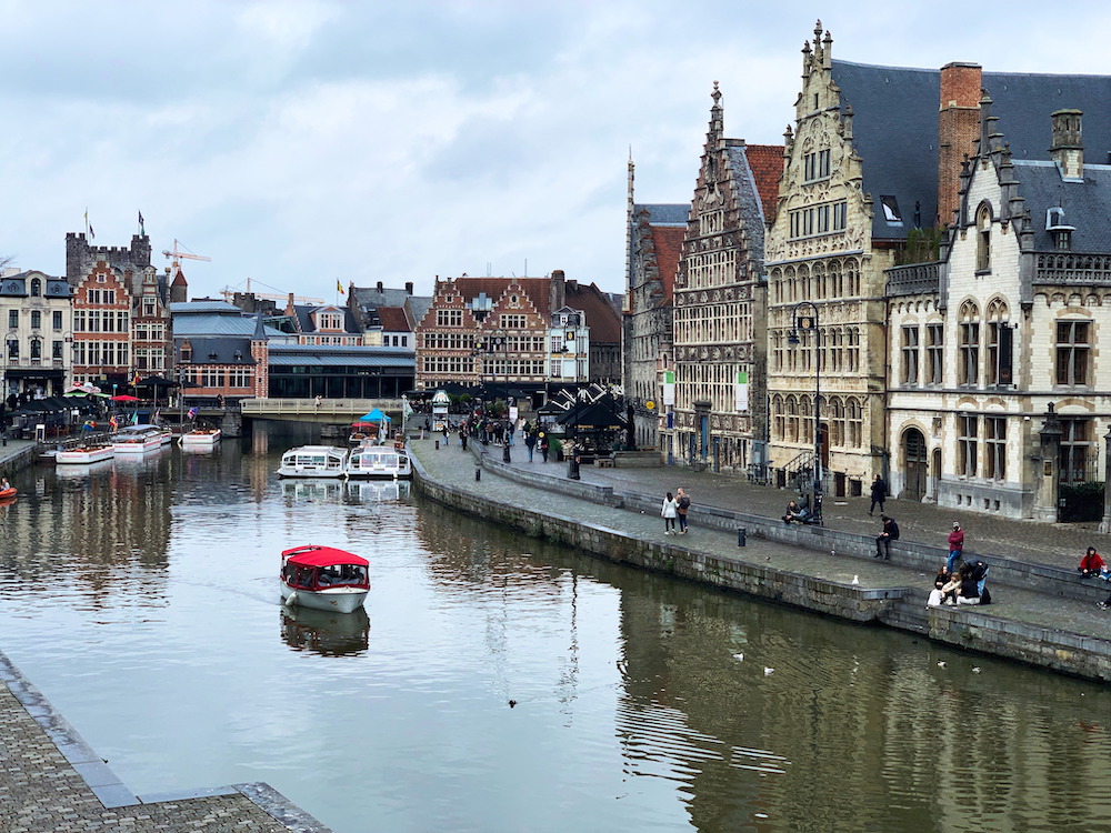 A canal tour boat on a river in Ghent