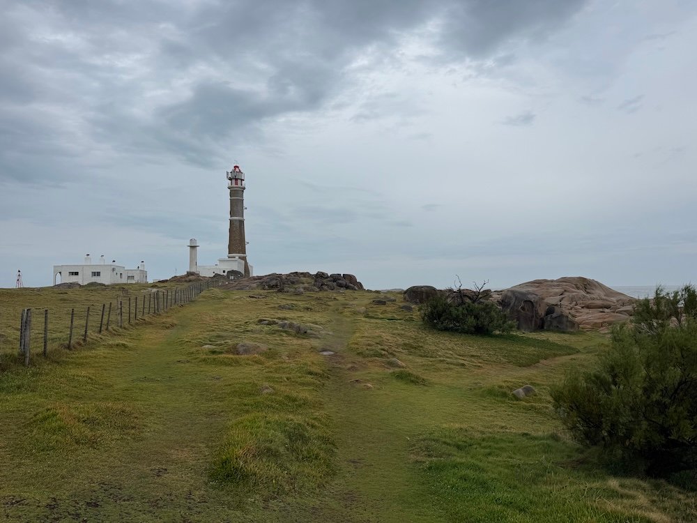 Lighthouse surrounded by green grass