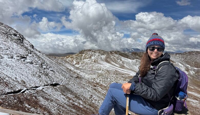Photo of the author surrounded my snow covered mountains
