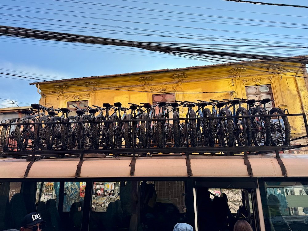 Bikes racked on top of a tour van