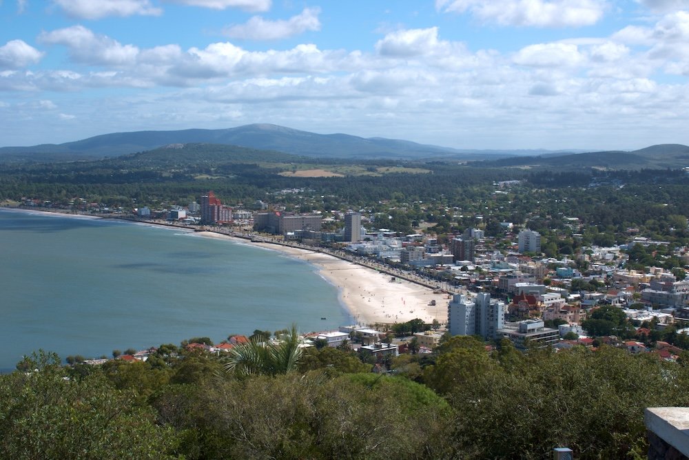 Overlook of Piriapolis featuring buildings, beach, and the river