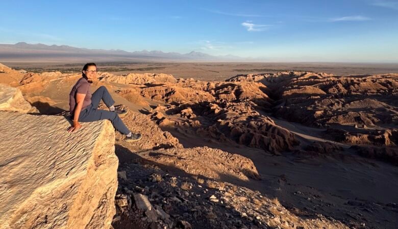 Author sitting on a rock near Moon Valley in San Pedro de Atacama, Chile