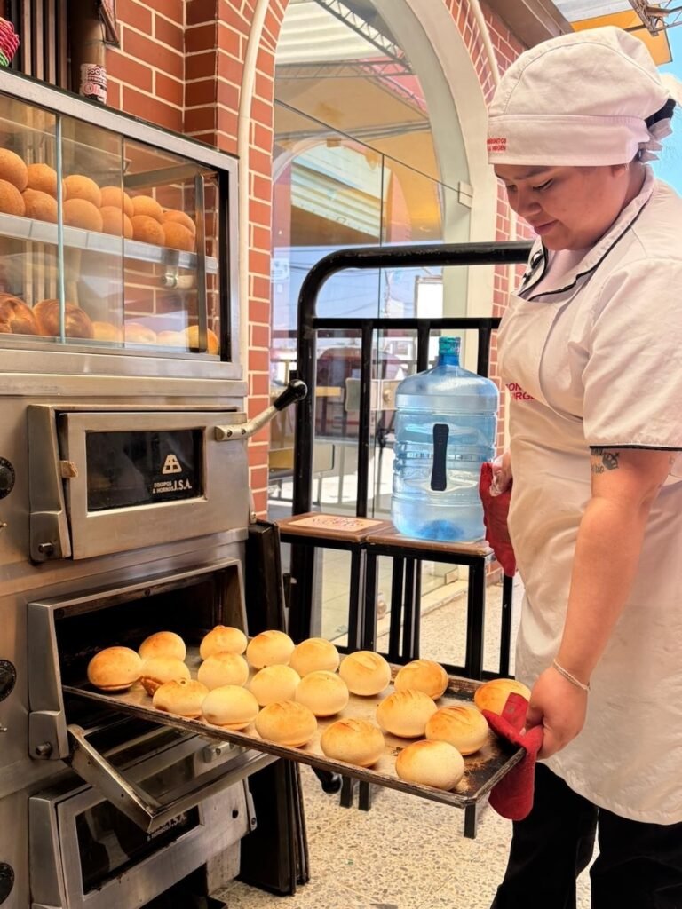 Woman with a fresh tray of pan de bolo