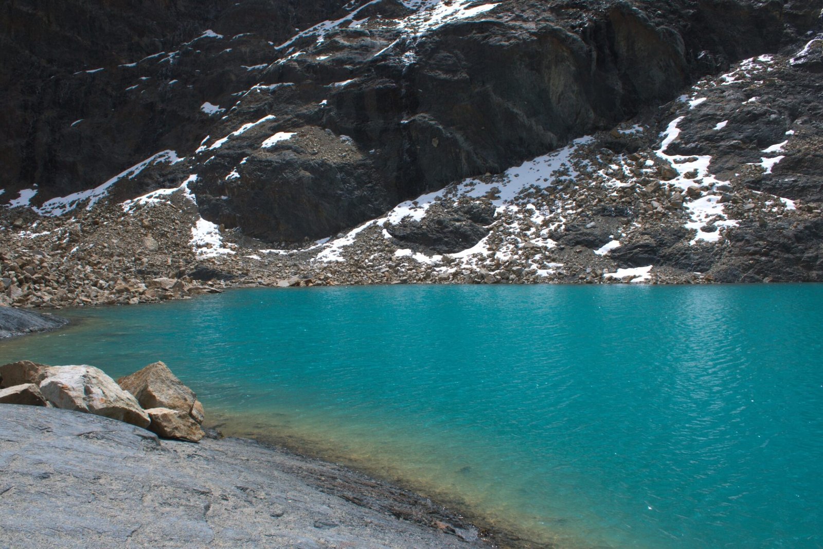Laguna Charquini surrounded by mountains