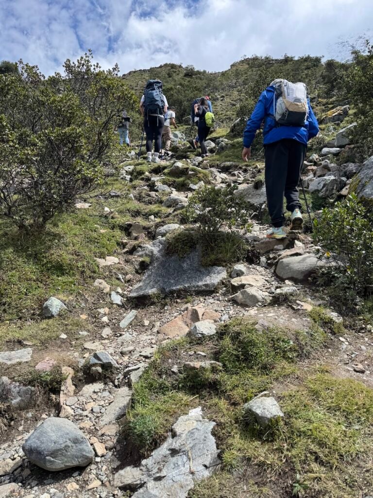 Hikers on a steep, rocky trail