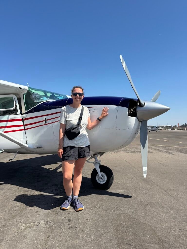 Photo of the author in front of a plane in Nazca, Peru