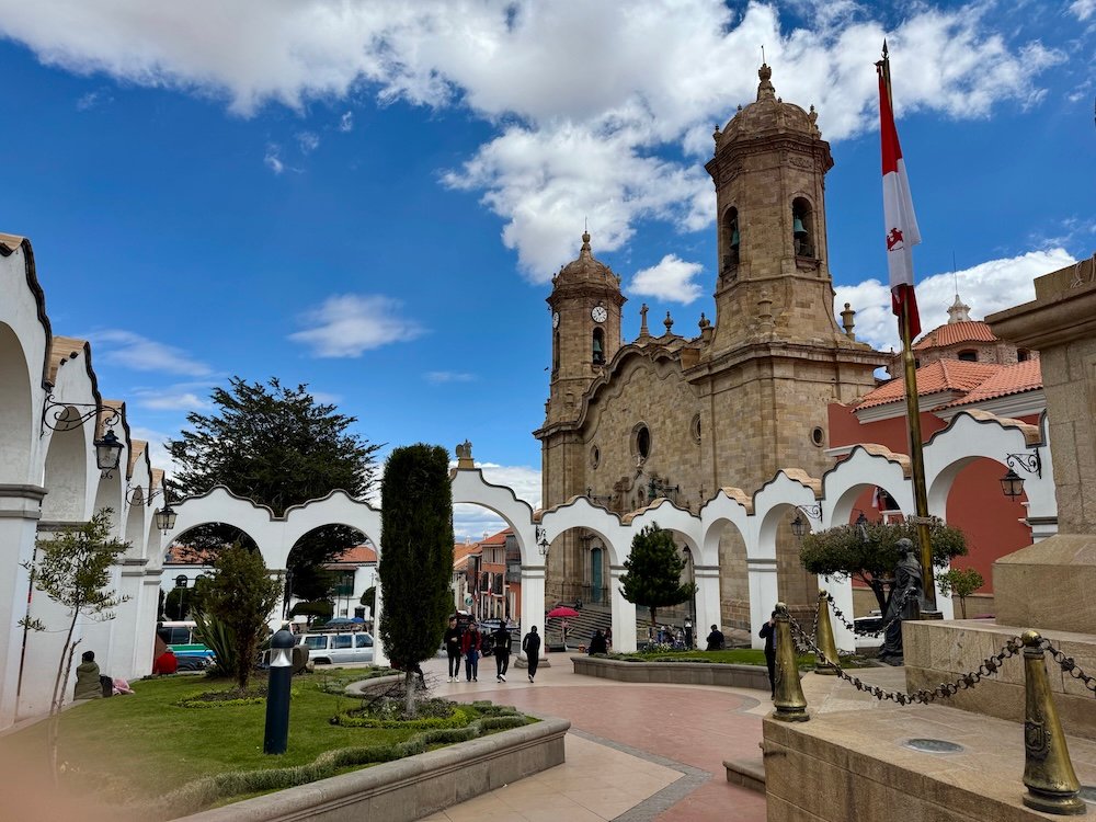 Square in Potosi, Bolivia featuring white arches and a cathedral