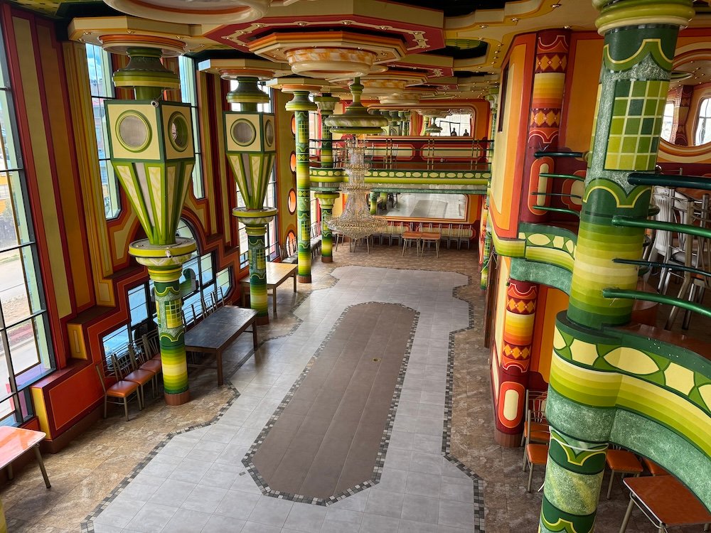 Interior of a cholet featuring bright orange and green decor